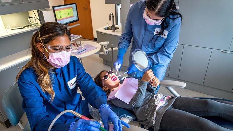 Dental Therapists working on young girl